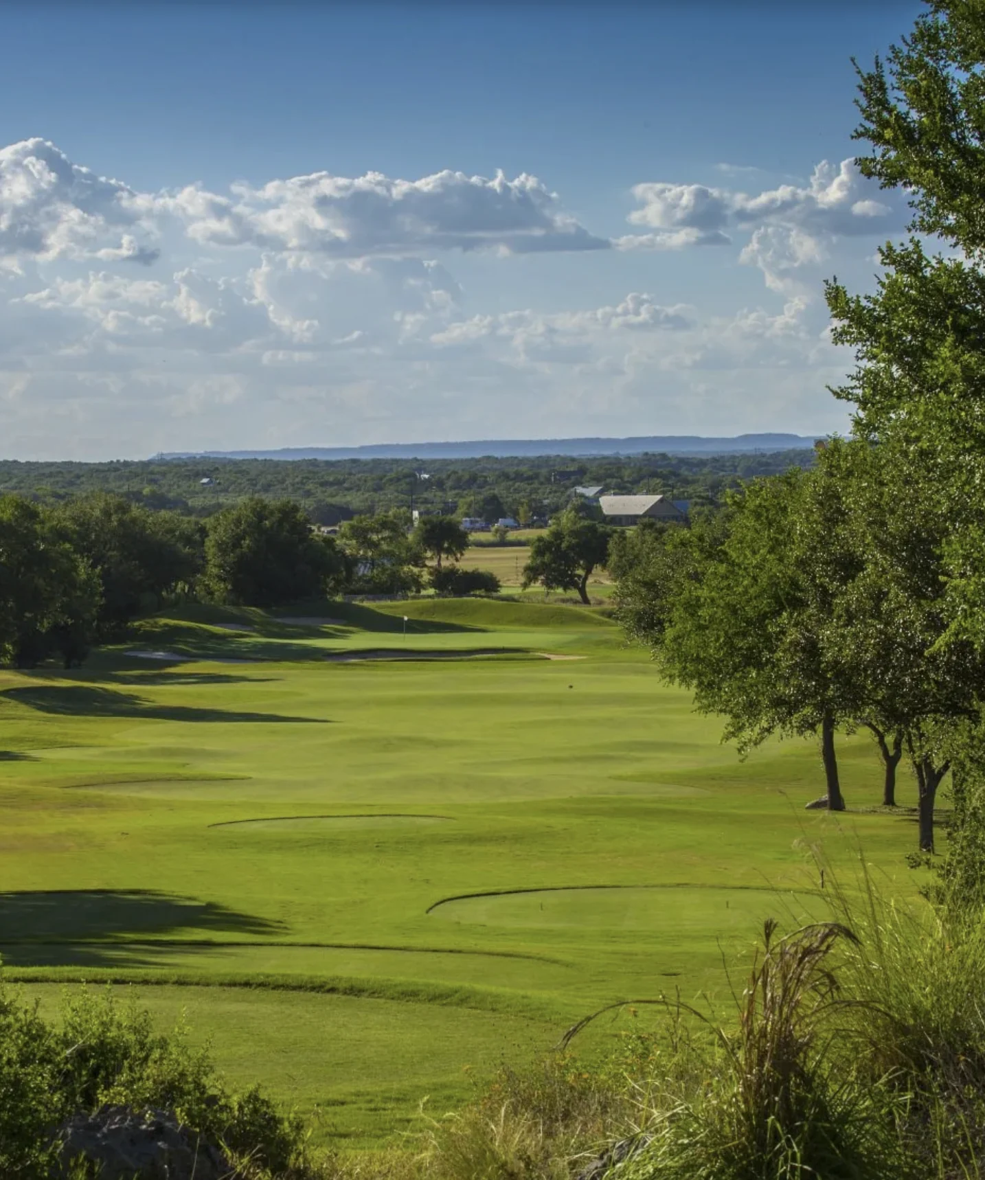 Tree-lined golf course fairway shown in Blackbird’s River Crossing event materials
